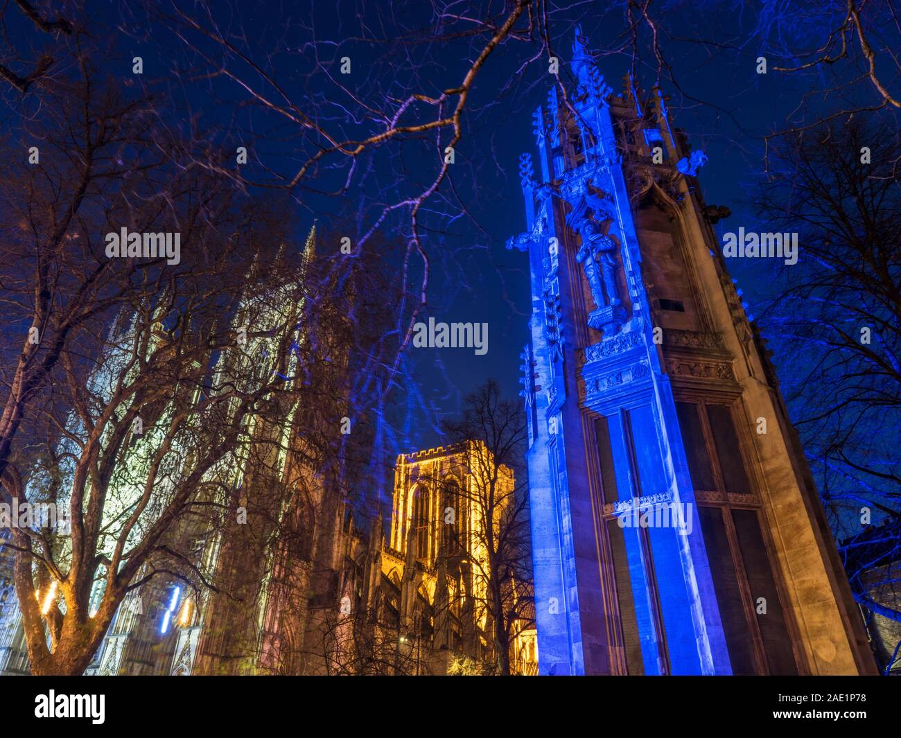 South African War Memorial bathed in blue light at dusk with York Minster behind at Duncombe Place City of York Yorkshire England Stock Photo