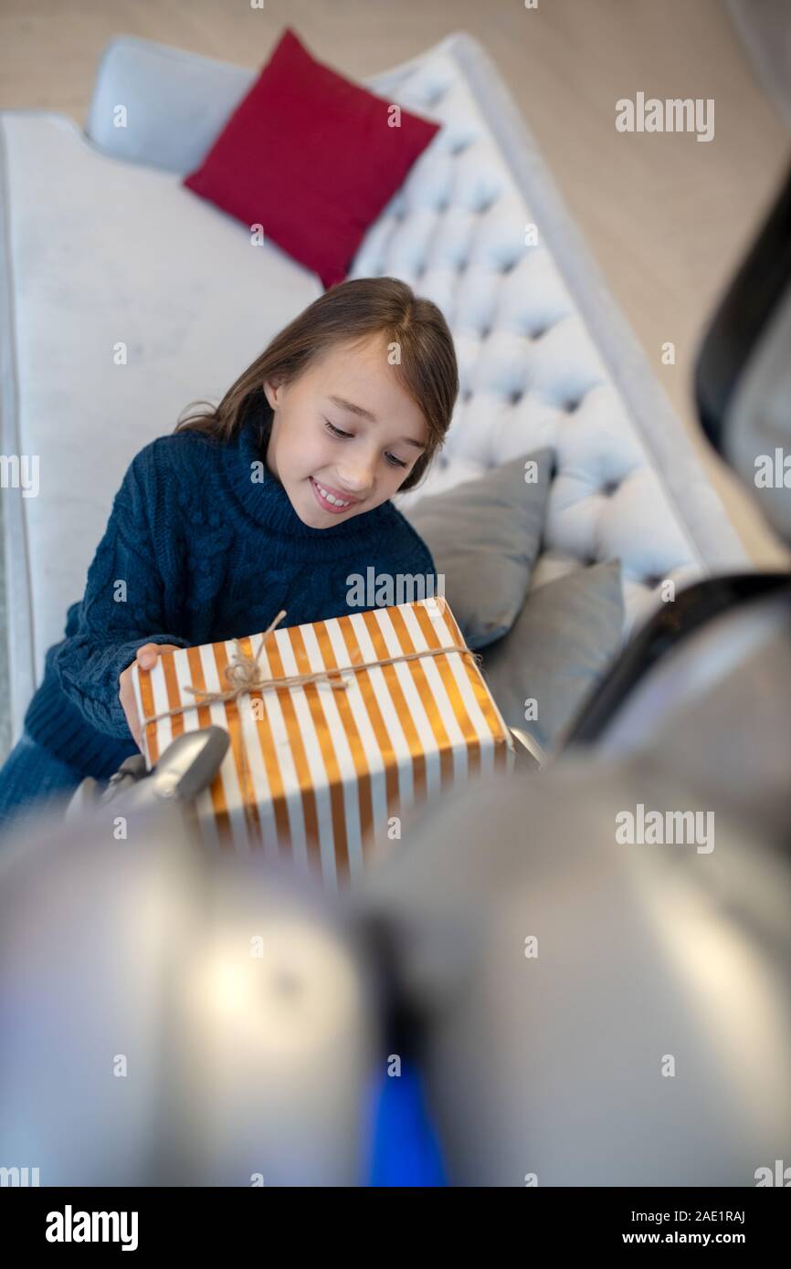 Happy cute girl holding a nice christmas gift Stock Photo - Alamy