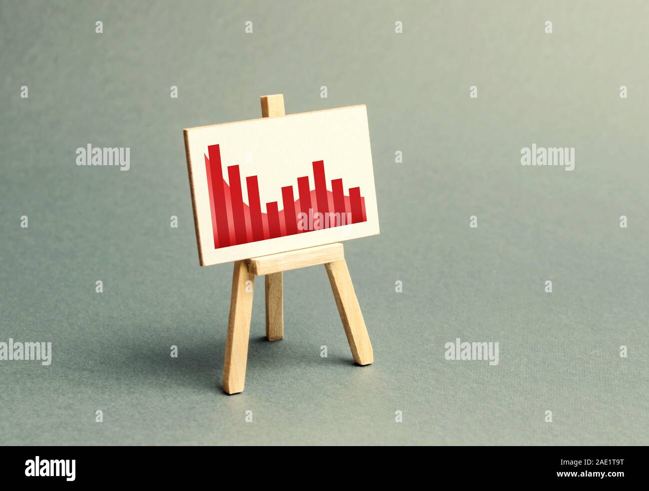 A stand with a canvas and a red downtrending trend. The concept of falling rates and indicators of the economy or production. The bad situation in the Stock Photo