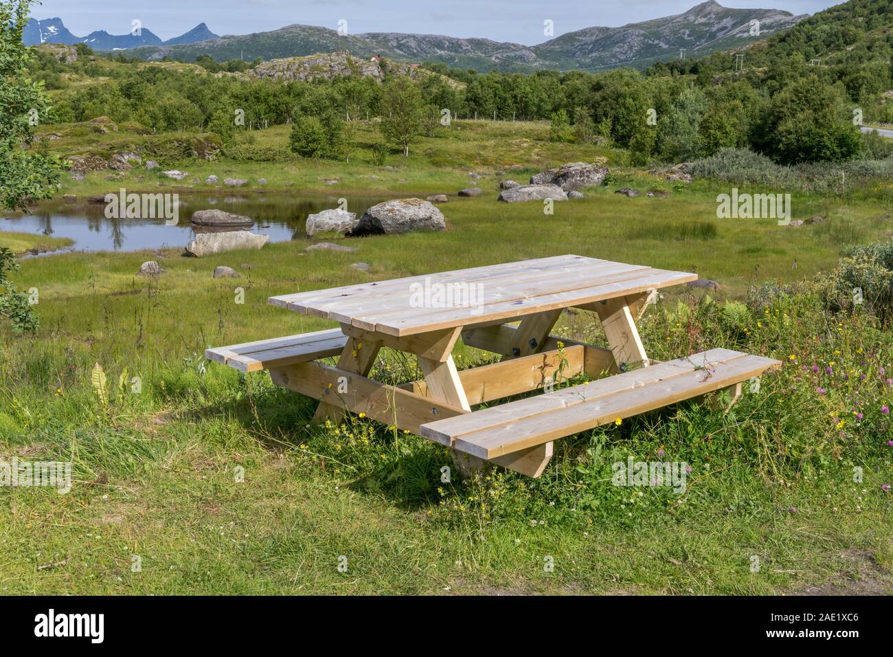 Arctic fjord landscape with wooden benche on shore at green inlet, shot ...