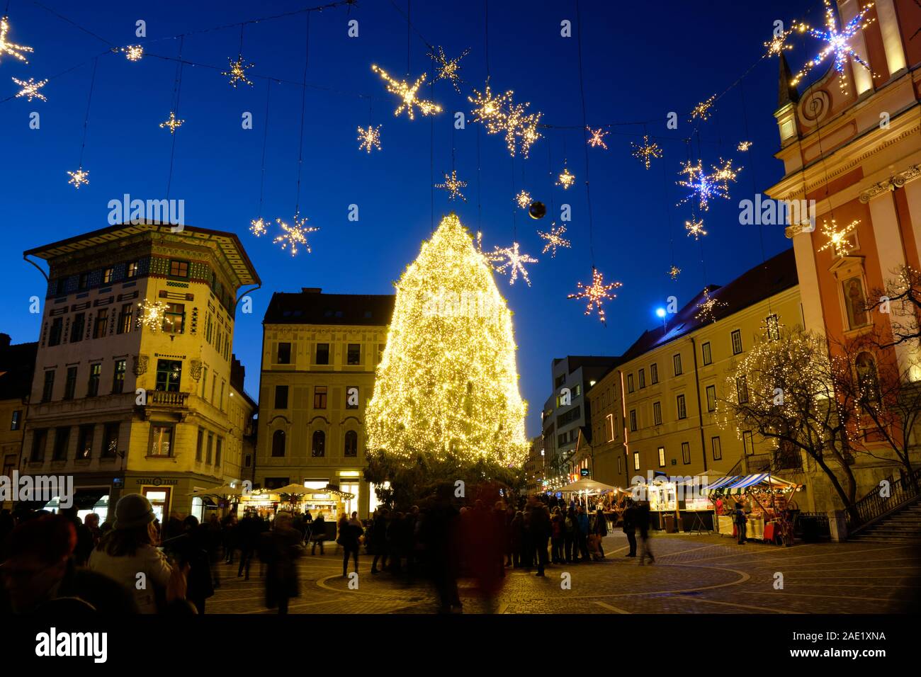 Night time Christmas Illumination with tree and hanging star in main Square. Ljubljana, Slovenia. Stock Photo