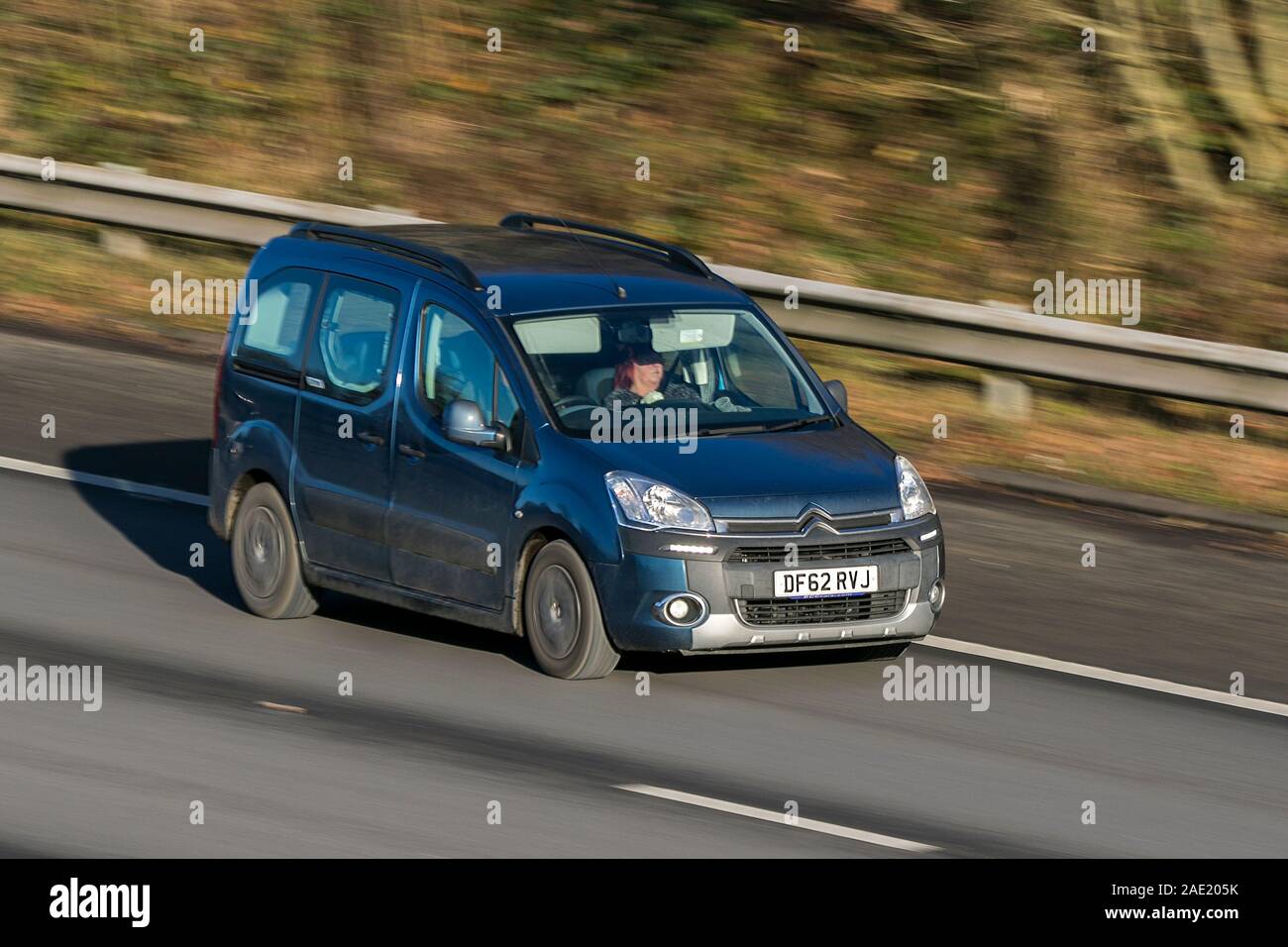 Blurred moving car 2012 Citroen Berlingo M-Sp Air Xtr E-Hdi Sa traveling at speed on the M61 motorway Slow camera shutter speed vehicle movement Stock Photo