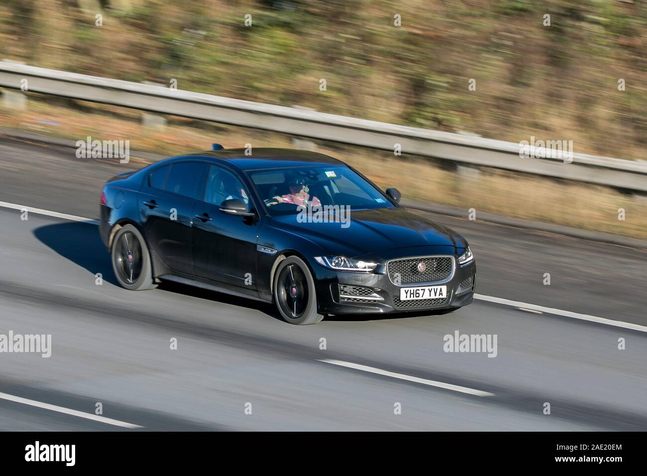 Blurred moving car JAGUAR Xe R-Sport I Auto traveling at speed on the M61 motorway Slow camera shutter speed vehicle movement Stock Photo
