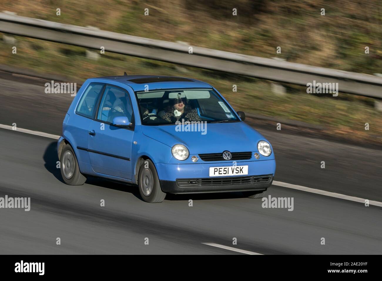 Blurred moving car VOLKSWAGEN Lupo E Auto traveling at speed on the M61 motorway Slow camera shutter speed vehicle movement Stock Photo
