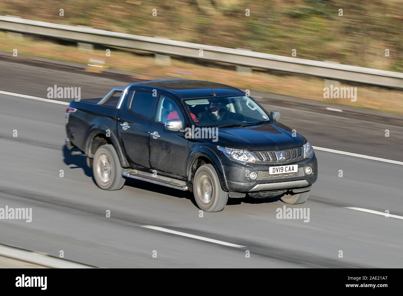 Blurred moving car Mitsubishi L200 Barbarian Di-D traveling at speed on the M61 motorway Slow camera shutter speed vehicle movement Stock Photo