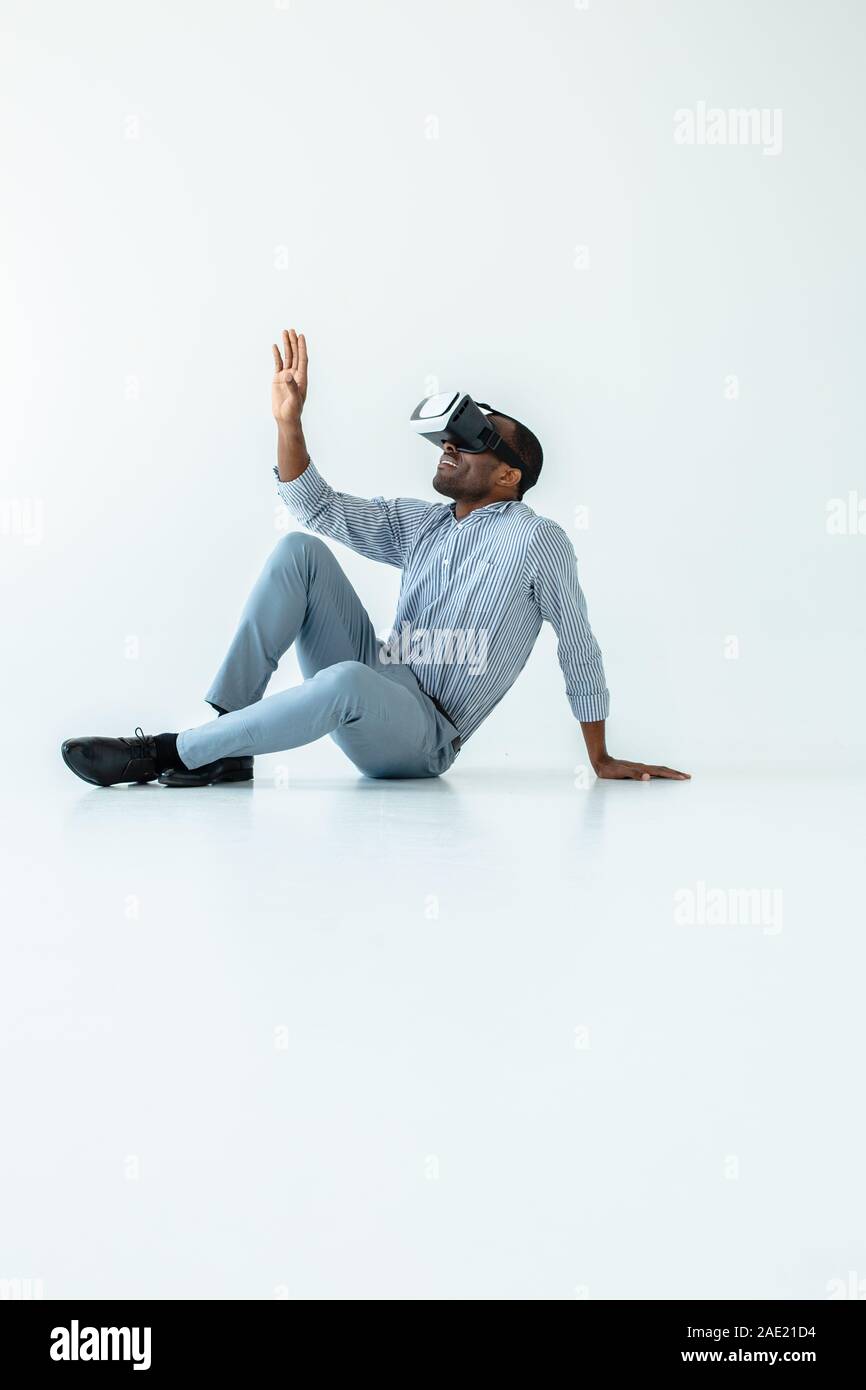 Smiling adult afro american man using vr device Stock Photo
