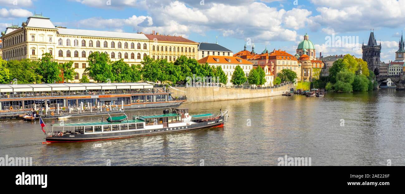 Marina Restaurant and riverboat ferry with tourists sightseeing and cruising on the Vltava River Prague Czech Republic. Stock Photo