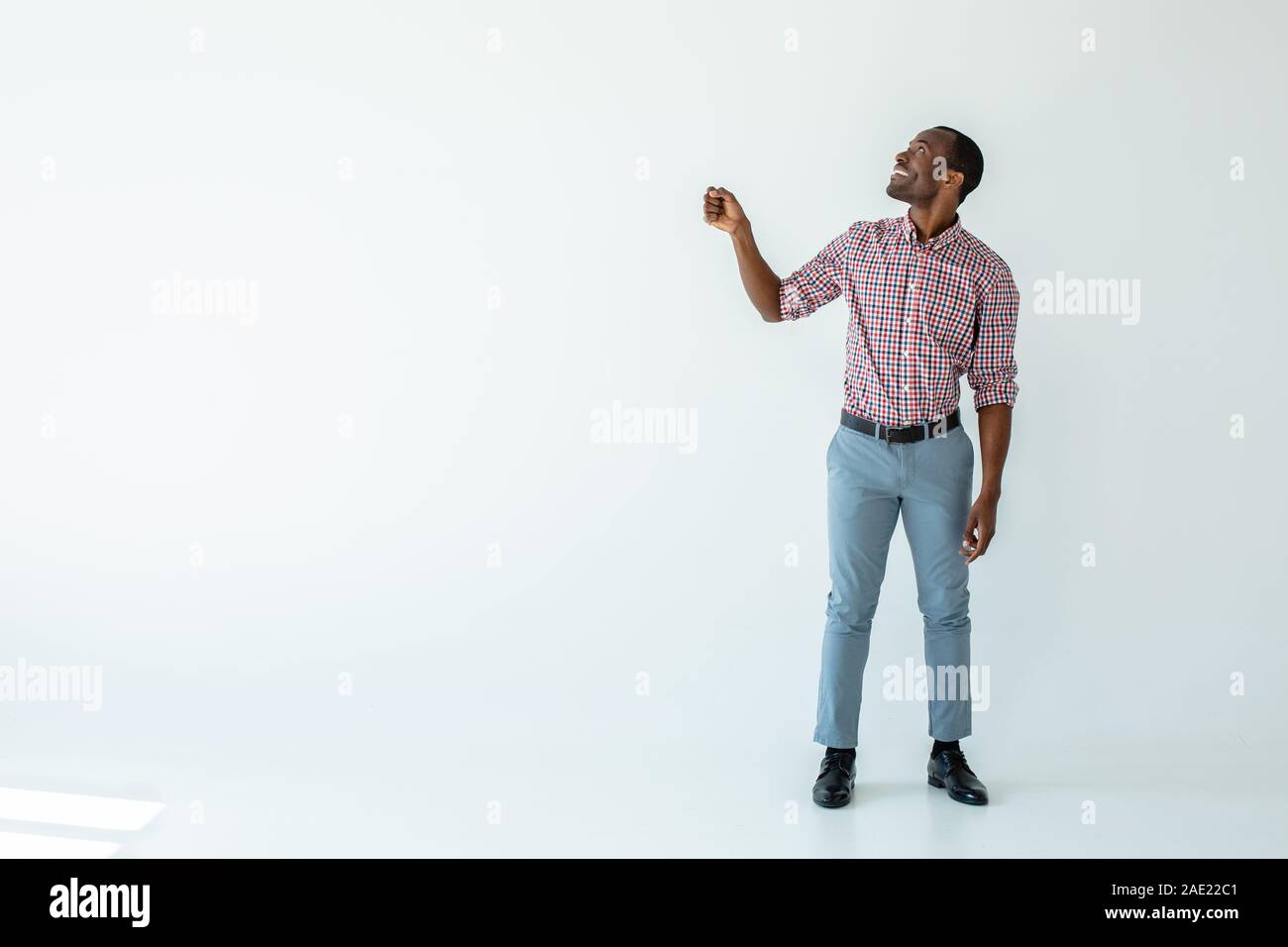 Joyful afro american man holding an umbrella Stock Photo