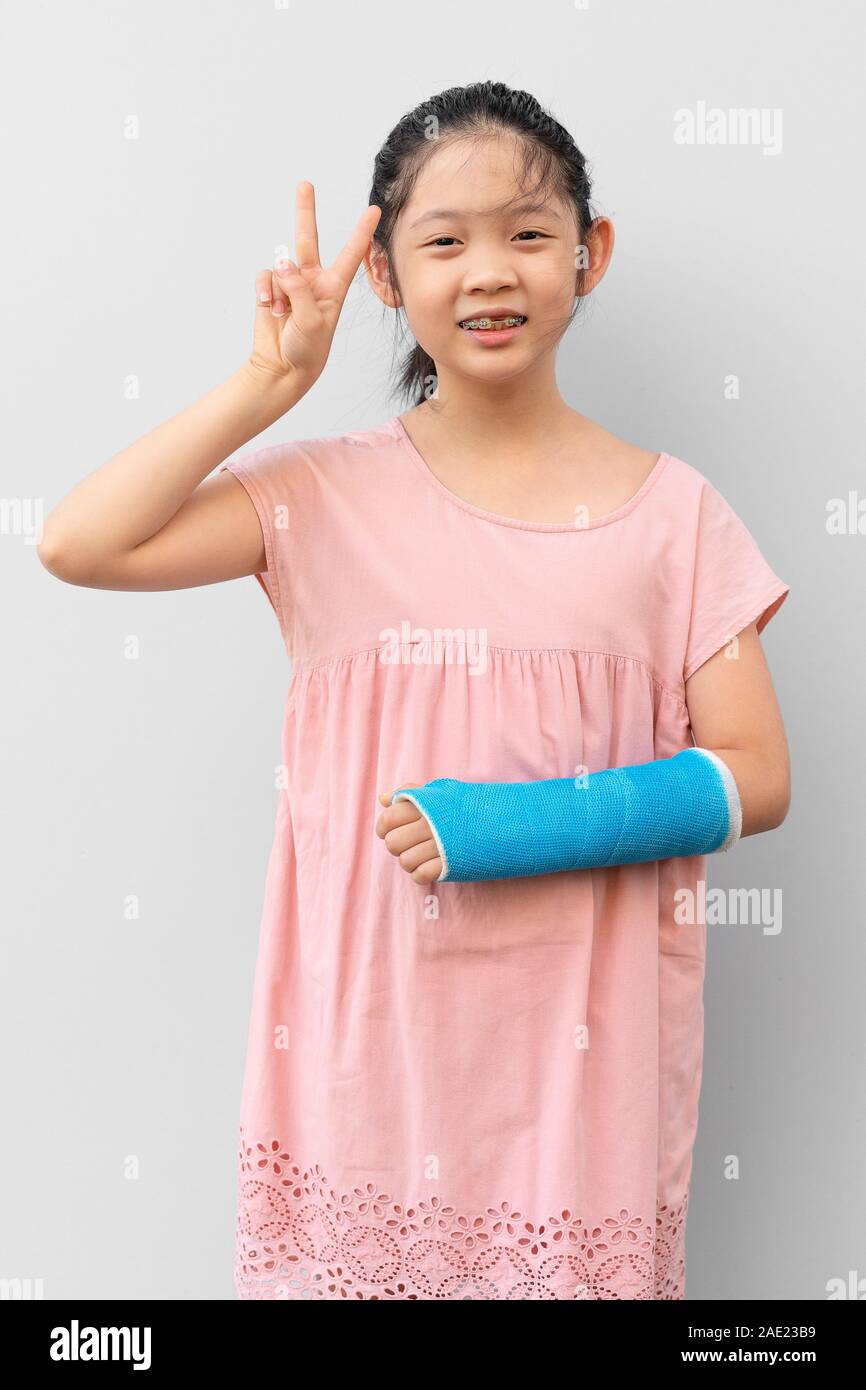 Asian Child with Broken Arm in Cast with Smiling Face Expression Stock
