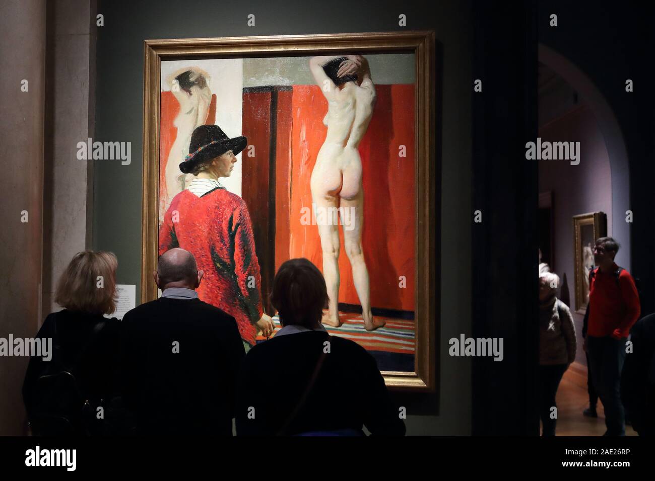 Visitors study a self-portrait with a model by Dame Laura Knight at the National Portrait Gallery, London, UK Stock Photo