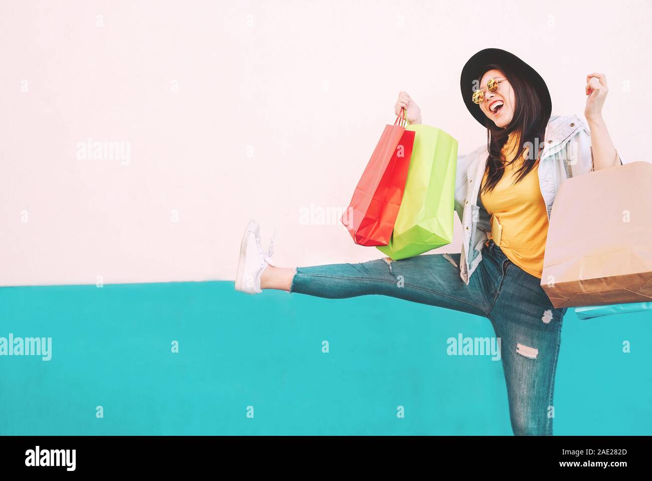 Asian fashion girl doing shopping in mall center - Happy Chinese woman having fun buying new clothes in vacation Stock Photo