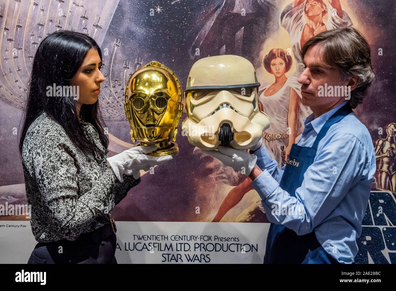 Promotional C 3po Helmet 19 Est 15 25 000 And Prototype Stormtrooper Helmet 1976 Est 30 60 000 In Front Of A Billboard Poster By Tom Jung 1977 Est 8 12 000 Sotheby S Previews Its Star Wars Online