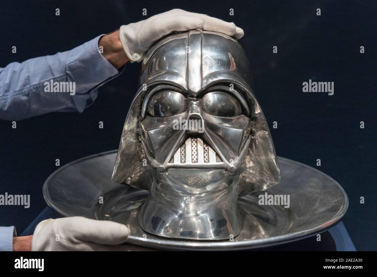 London, UK.  6 December 2019. A staff member poses with 'Bring Me The Head Of Darth Vader', 1999, by Clive Barker  (Estimate GBP6,000-9,000), at the preview of 'Star Wars Online', a sale dedicated to Star Wars collectibles encompassing 100 lots from the franchise.  Sotheby's will host the online-only sale which will run until 13 December, ahead of the final film in the sequel trilogy 'Star Wars: The Rise of Skywalker'.  Highlights from the sale are on display at Sotheby's New Bond Street 6 to 11 December.  Credit: Stephen Chung / Alamy Live News Stock Photo