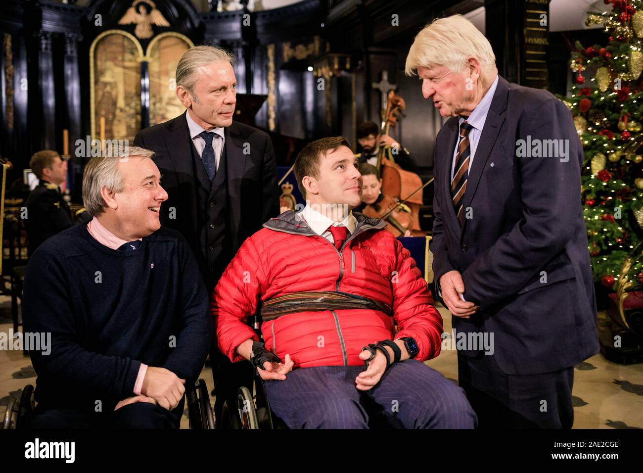 Stanley Johnson and Bruce Dickinson pictured chatting alongside two of the charity’s Ambassadors Bob Greig and Rob Bugden both former Parachute Jump Instructors.  The Royal Air Force Benevolent Fund Christmas Carols at St Clement Danes, London 5th Dec 2019.  The central London church, which bisects Fleet Street, heard Christmas classics sung by veterans from across the RAF’s storied past and backed by the RAF Salon Orchestra, Military Wives Choirs and RAF Air Cadets London Wing Choir.   The charity, which turned one hundred this year, asked singers to Join the Search. Change a Life. The campai Stock Photo