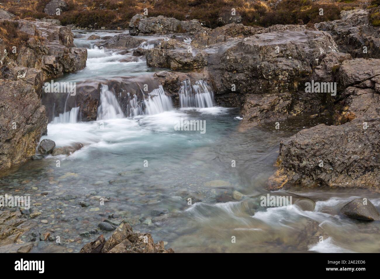 Fairy Pools with waterfalls at the river Brittle, Isle of Skye, Scotland, UK in March - long exposure Stock Photo