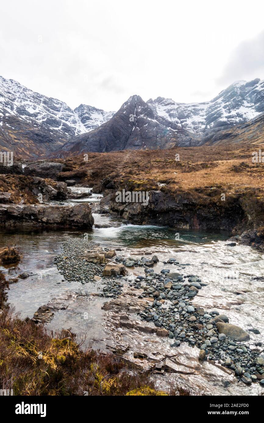 Fairy Pools with low cloud over the Black Cuillin mountains with waterfalls at the river Brittle, Isle of Skye, Scotland, UK in March - long exposure Stock Photo