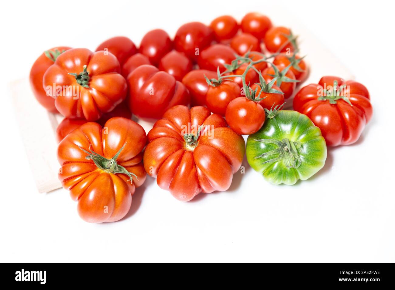 A composition of various types of tomatoes, such as the Florentine Costoluto, the cherry and the datterino. Typical in the Mediterranean diet tomatoes Stock Photo