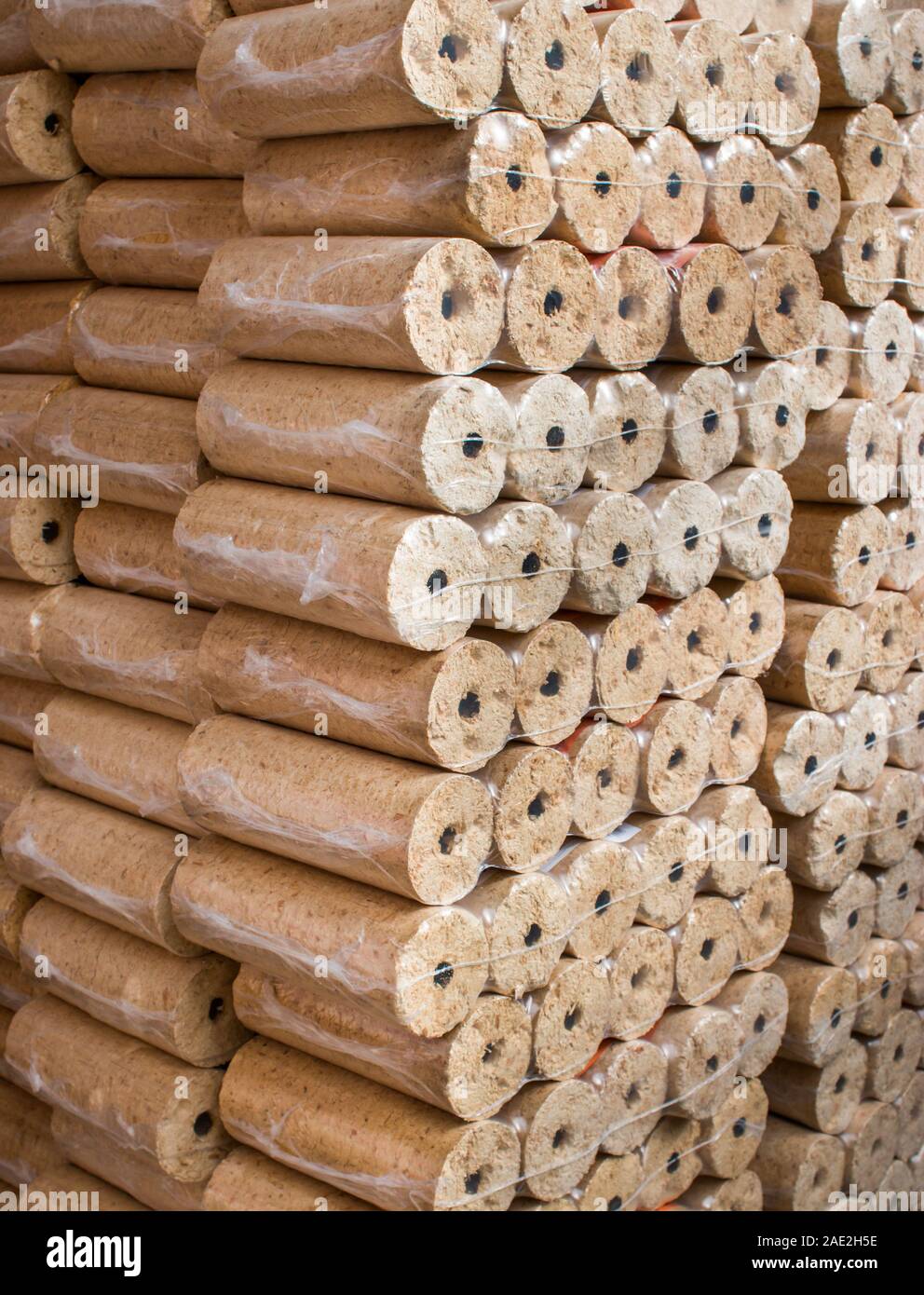 Wood briquettes for heating, packed in plastic film Stock Photo - Alamy