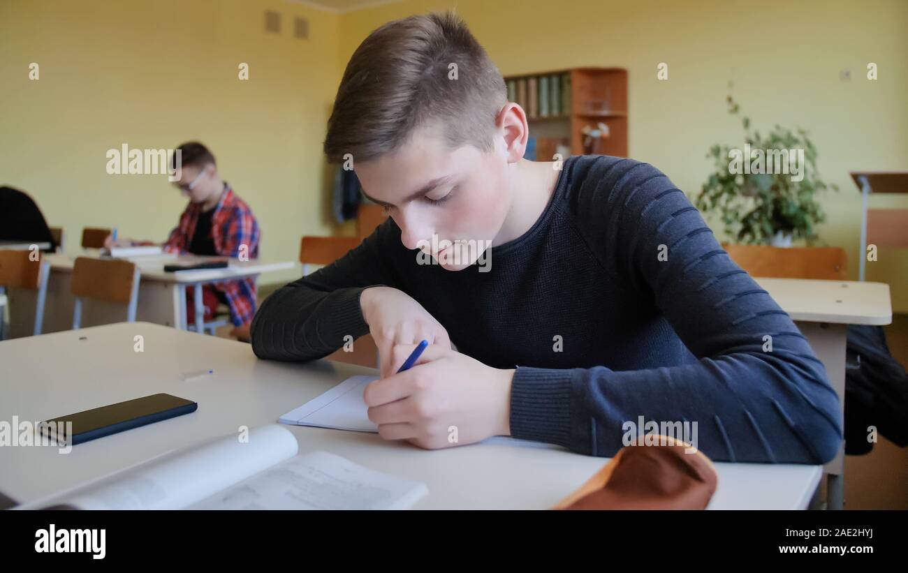 Schoolchild in class busy with work. Russian school. Stock Photo