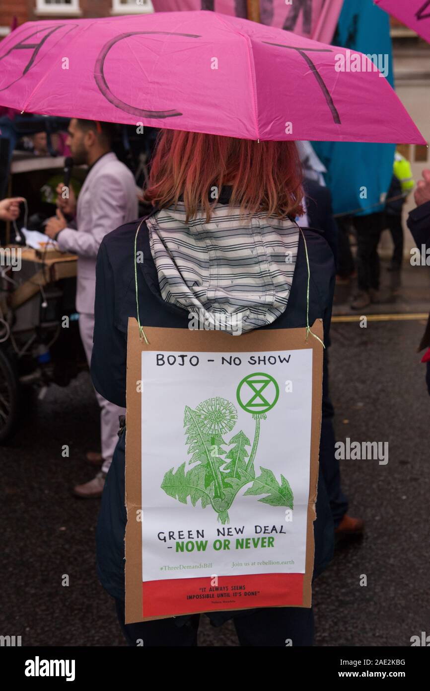 London, UK, 6 December 2019: Extinction Rebellion protestors paraded through Westminster today with a 4-metre high ostrich with it's head in the sand. Symbolising the main political parties' attitudes to the climate crisis, the ostrich was accompanied by a flash mob who danced to 'Where's Your Head At' and 'Staying Alive' outside the party headquarters of the Conservatives, Liberal Democrats and Labour Party. Anna Watson/Alamy Live News Stock Photo