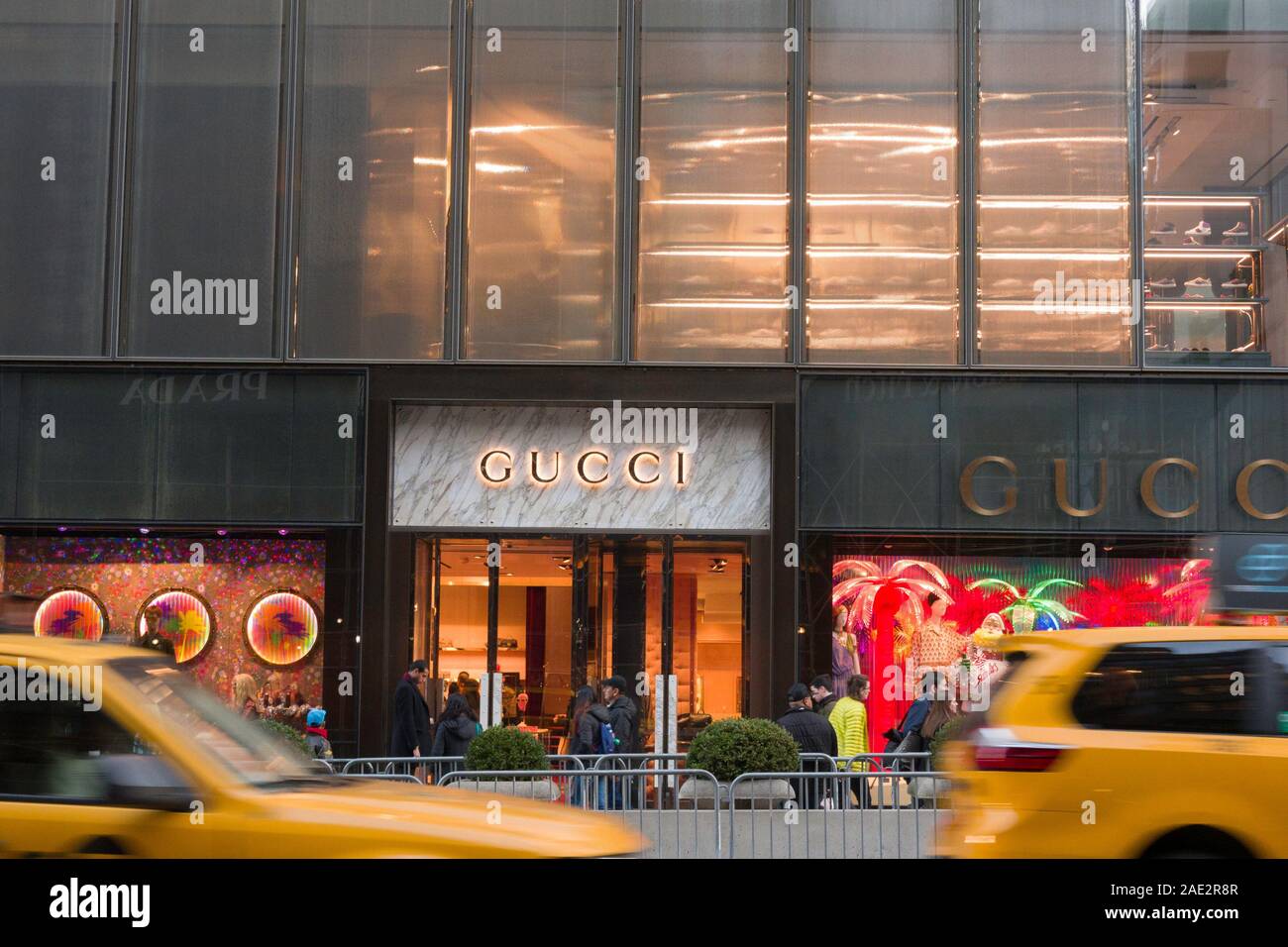 People shop in the Gucci department at a Saks Fifth Avenue store