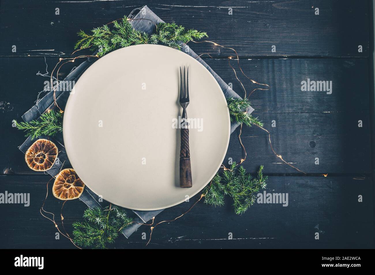 Festive Christmas table setting with a rustic vintage crockery on a dark background. Copy space Stock Photo