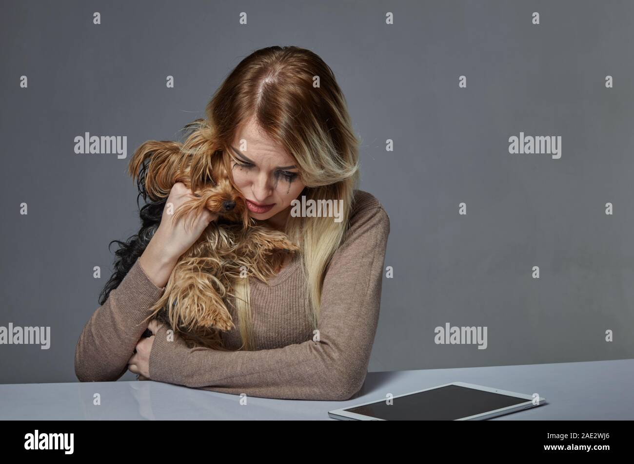 Woman with dog suffering from stress Stock Photo