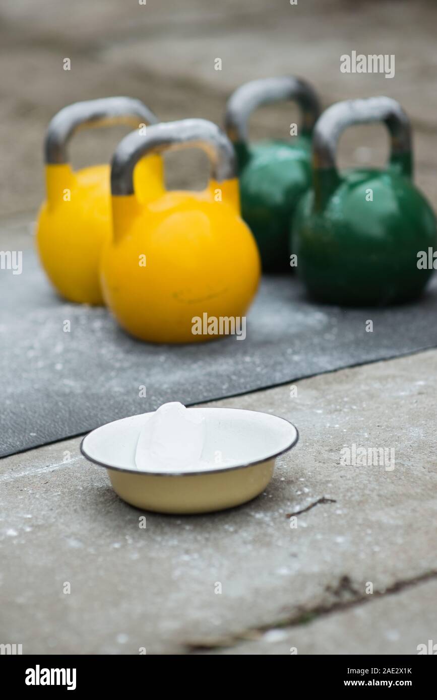 Old used kettlebell outside on the floor ready for strength and