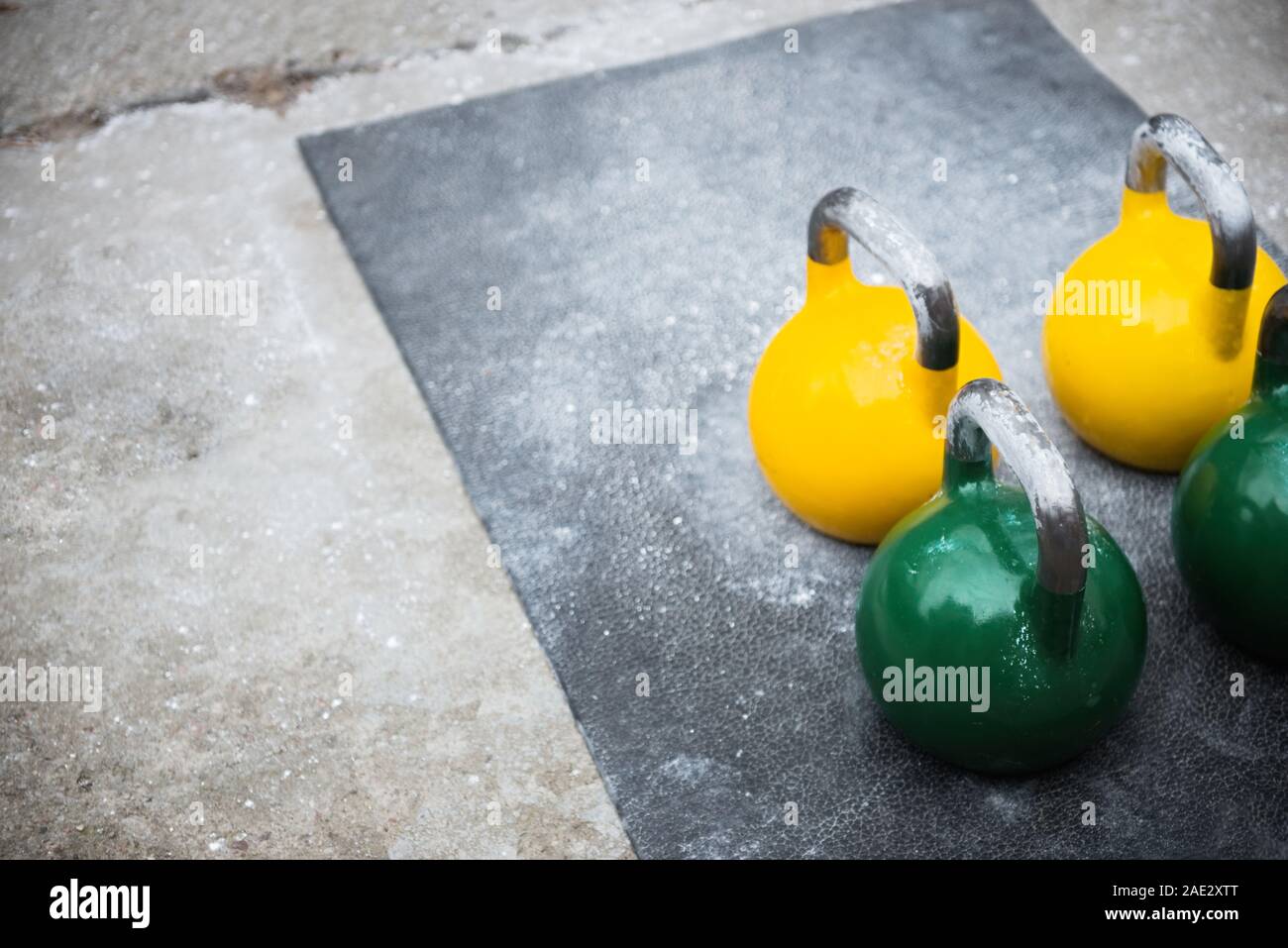 Old used kettlebell outside on the floor ready for strength and