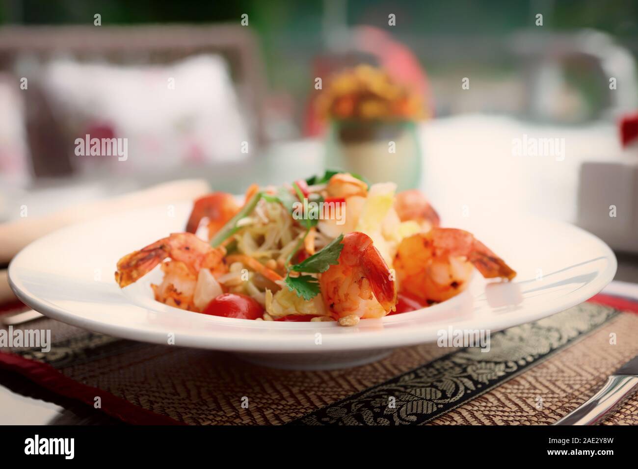 Shrimp appetizer, light summer dish on restaurant table outdoors, toned image Stock Photo