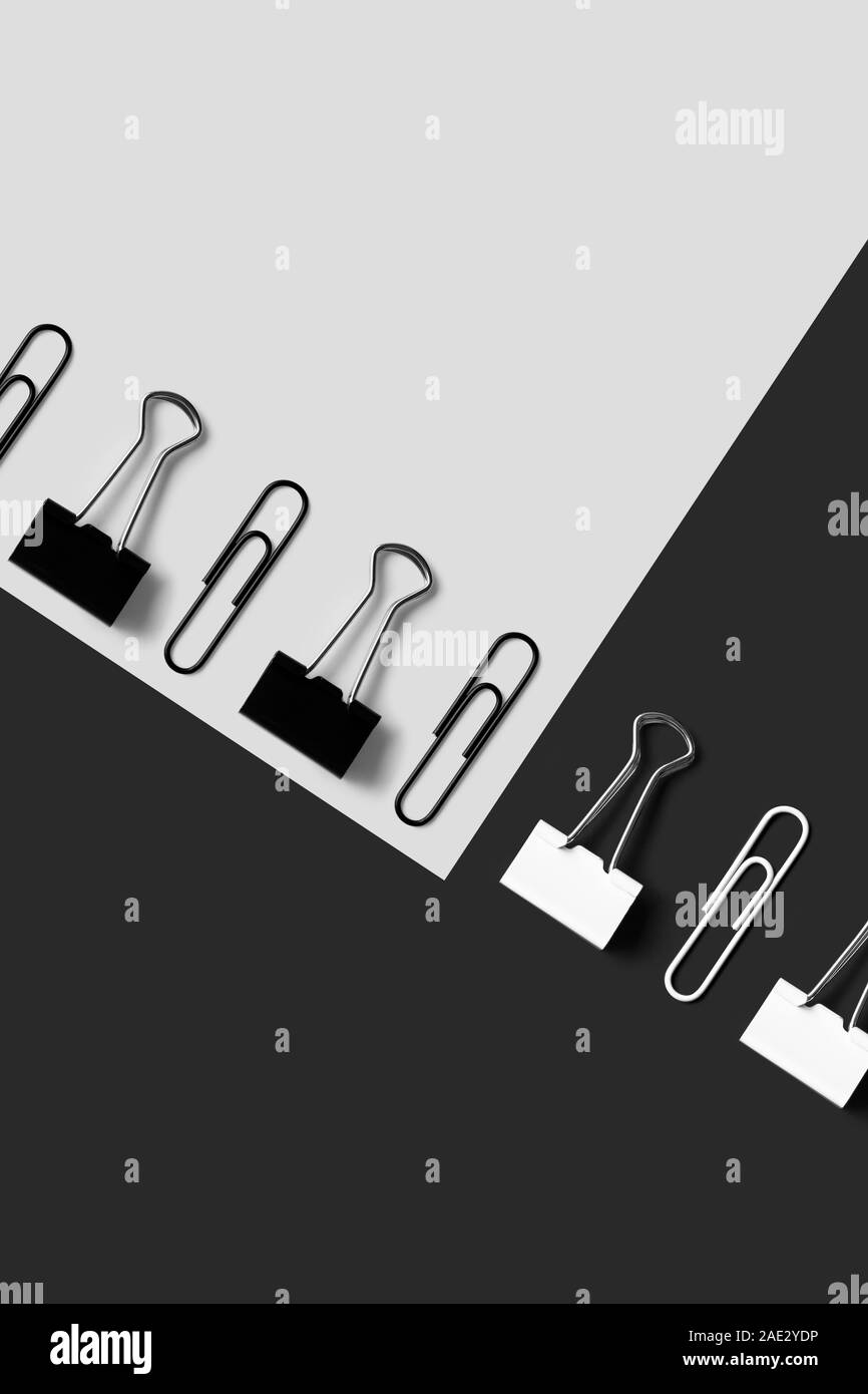 Black and white office supplies, paper clips and binder clips organized