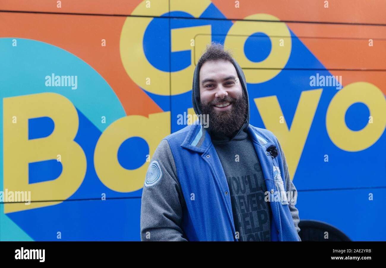 Hamburg, Germany. 06th Dec, 2019. Dominik Bloh, GoBanyo project initiator, stands in front of the logo of the shower bus. The vehicle, a crowdfunded project, offers three washrooms and showers for the homeless. Credit: Markus Scholz/dpa/Alamy Live News Stock Photo