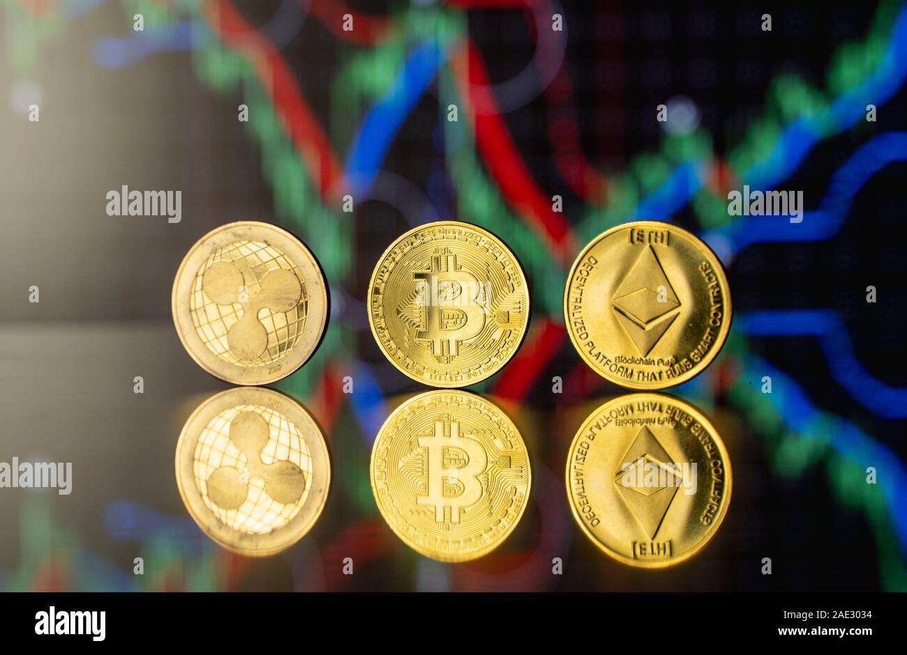 Cryptocyrrency and virtual money concept. Golded bitcoin, ethereum and  ripple coins with chart of growing and falling valuance of a cryptocurrency  Stock Photo - Alamy