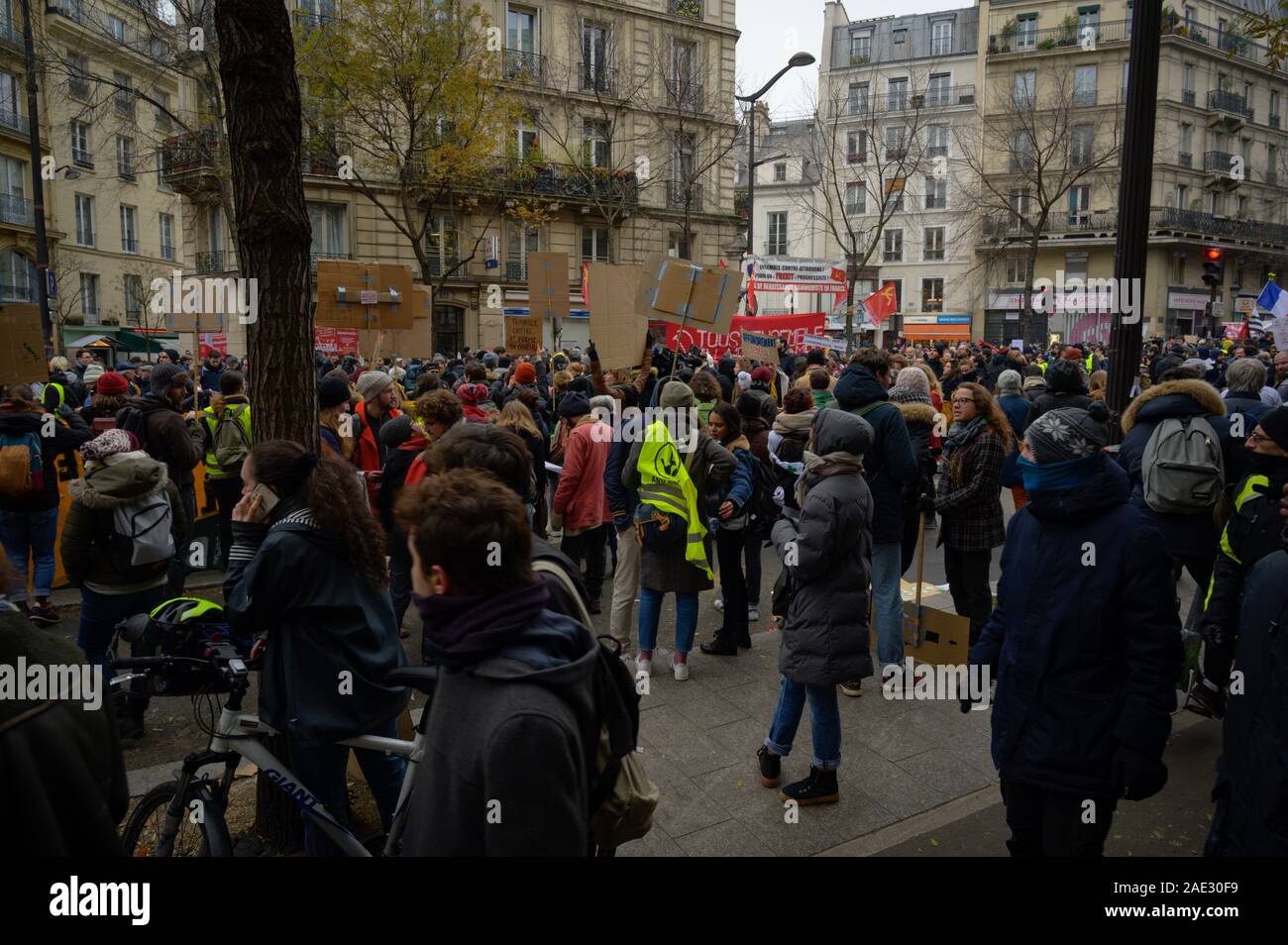 PARIS, FRANCE, DECEMBER 05 2019 : a crowd assembles on Boulevard Magenta during a 'Gilets Jaunes' (Yellow Vests) protest. Stock Photo