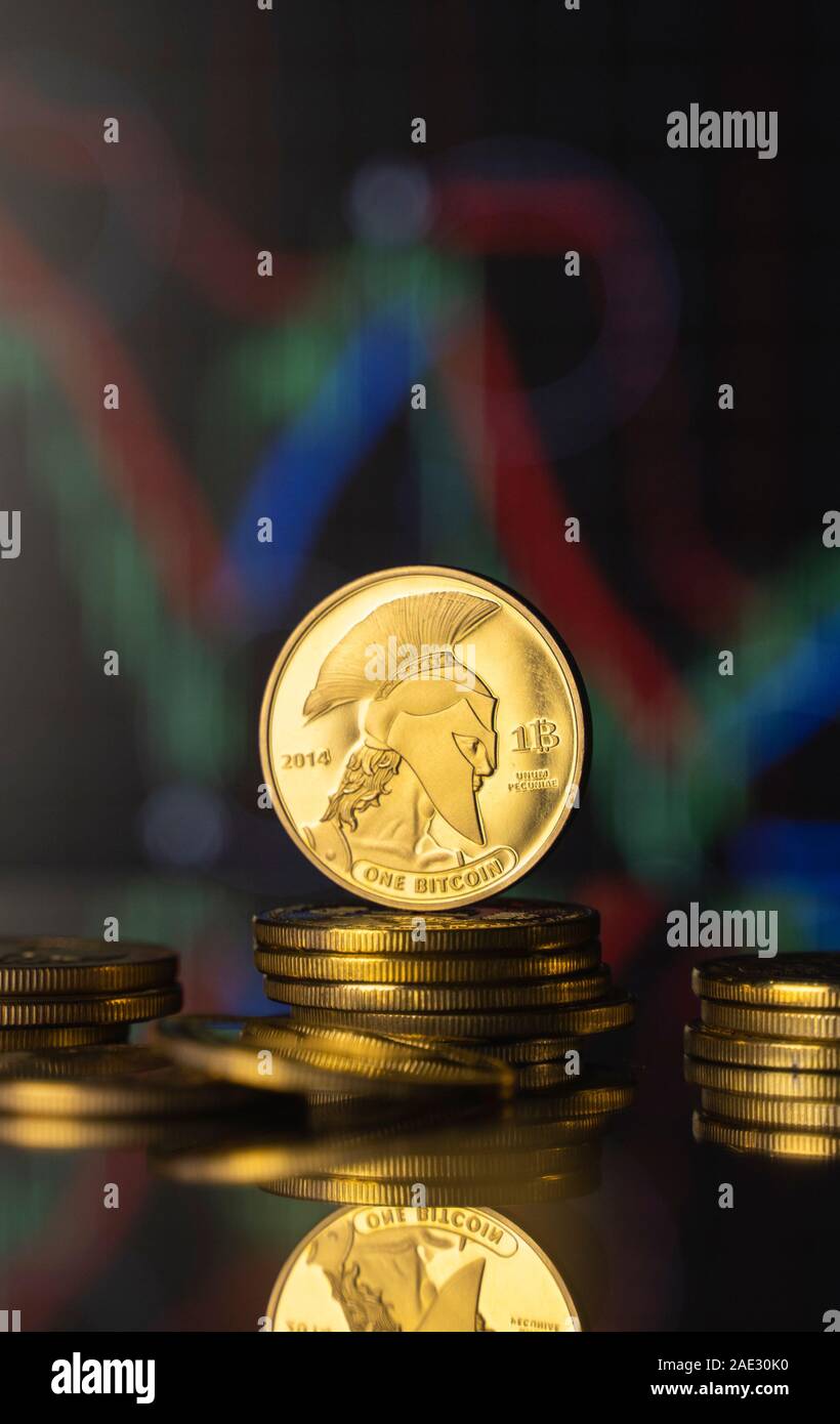 Titan bitcoin and virtual money concept. Gold Titan on a stack of coins  with chart of growing and falling valuance of a cryptocurrency. Mining or  Stock Photo - Alamy