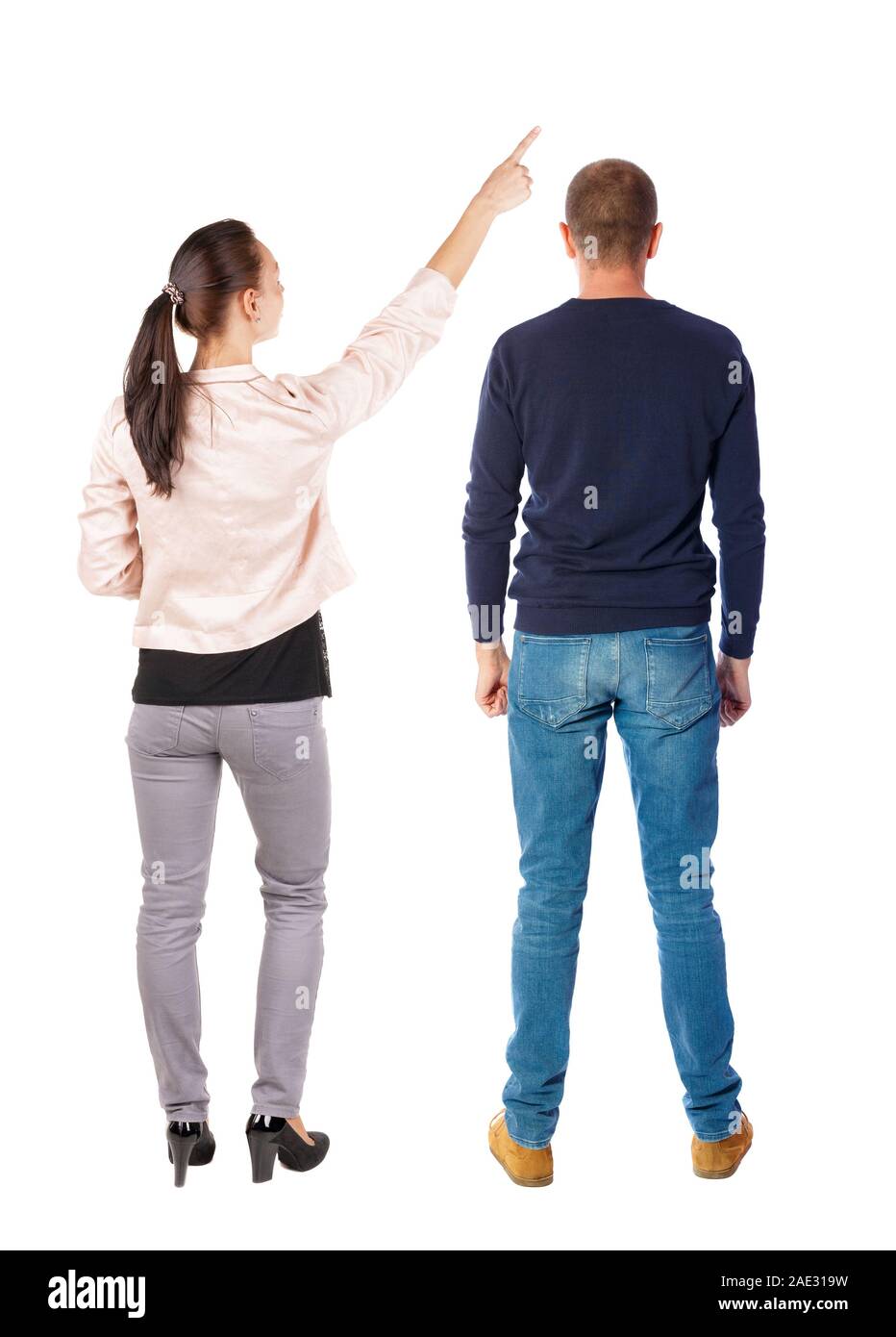 Back view of a stylish couple pointing. beautiful friendly girl and guy ...