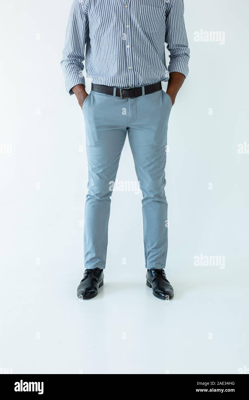 Low angle of serious man standing against white background Stock Photo ...