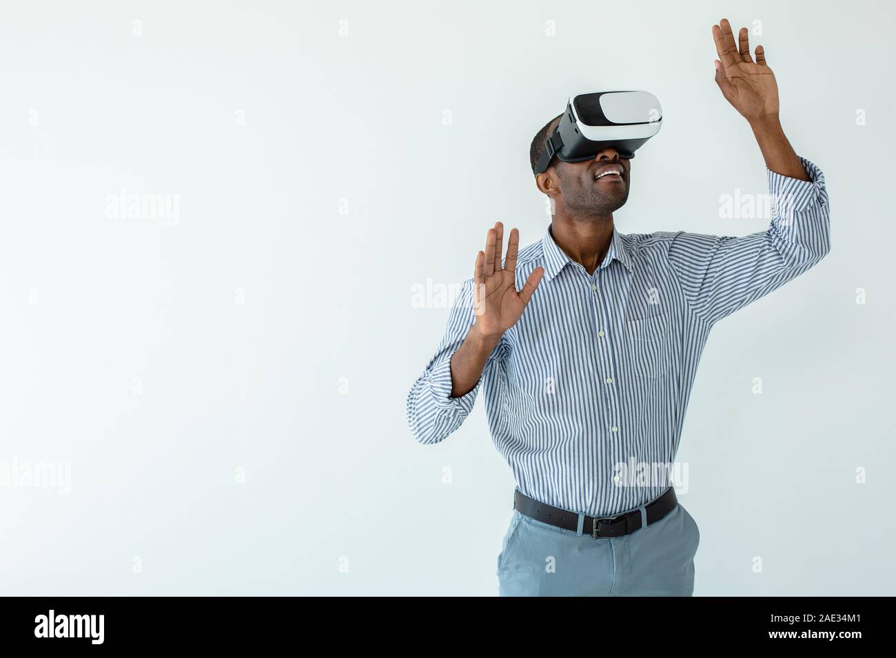 Smiling afro american businessman testing VR device Stock Photo
