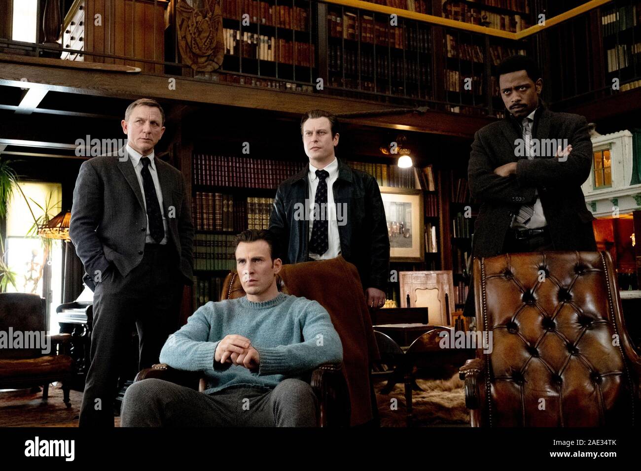 KNIVES OUT, standing from left Daniel Craig, Noah Segan, LaKeith