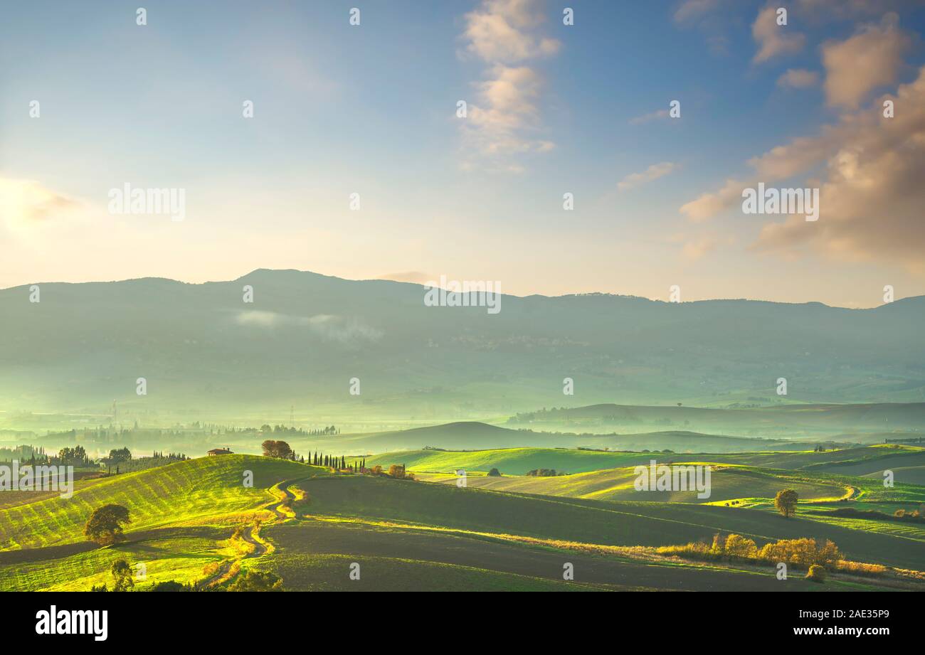 Tuscany countryside misty panorama, rolling hills and green fields on sunset. Pomaia Santa Luce, Pisa Italy, Europe Stock Photo