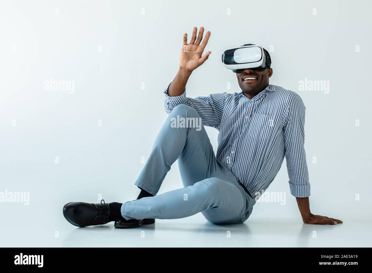Cheerful afro american man using VR gadget Stock Photo