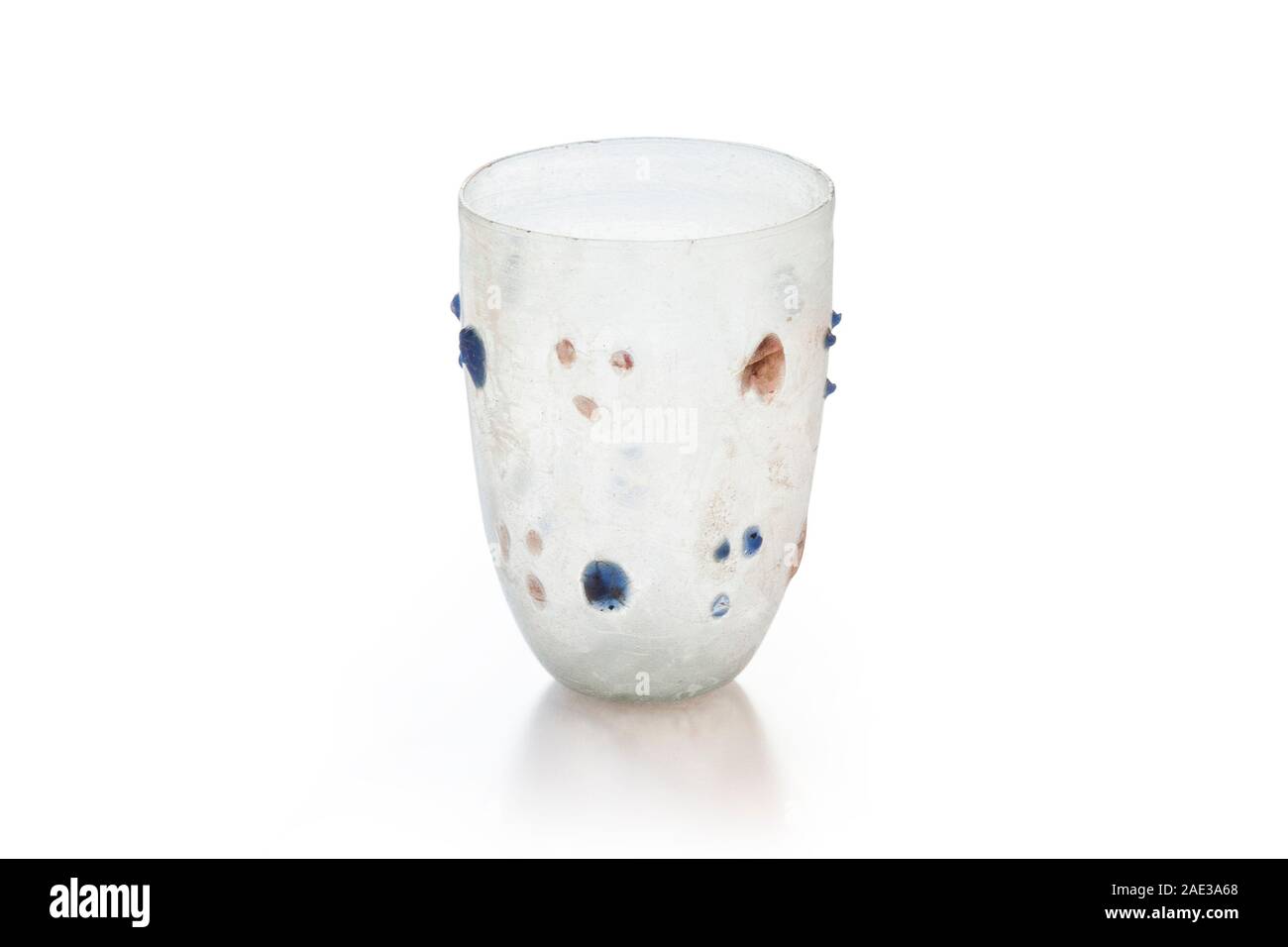 Ancient Roman cup with large and small nubs. Mould-blown glass and with coloured nubs. 3rd-4th century A.D. Clipping path for design purpopes. Stock Photo