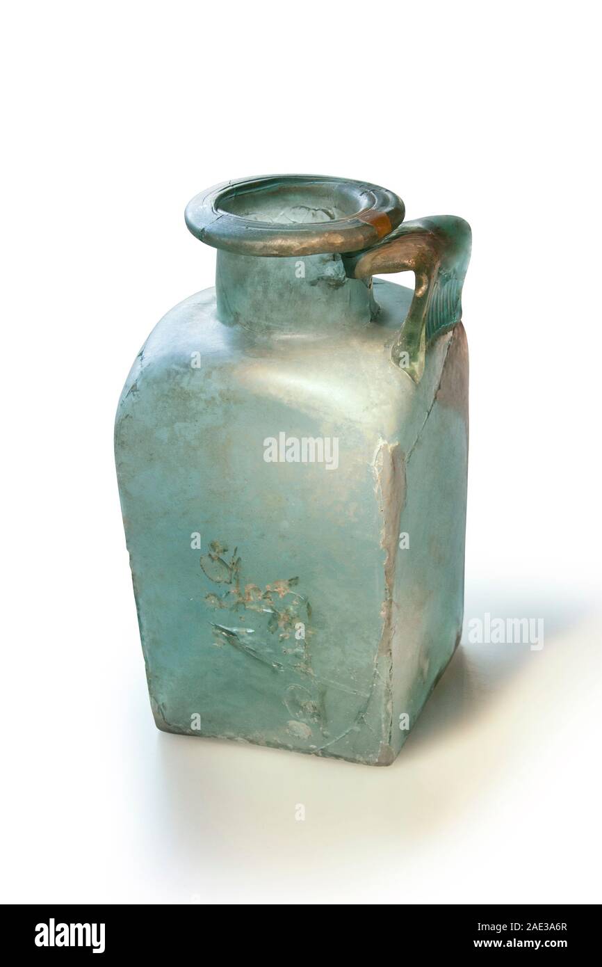Ancient Roman square bottle with handle from molten glass. 3rd and 4th centuries. Clipping path for design purpopes. Stock Photo