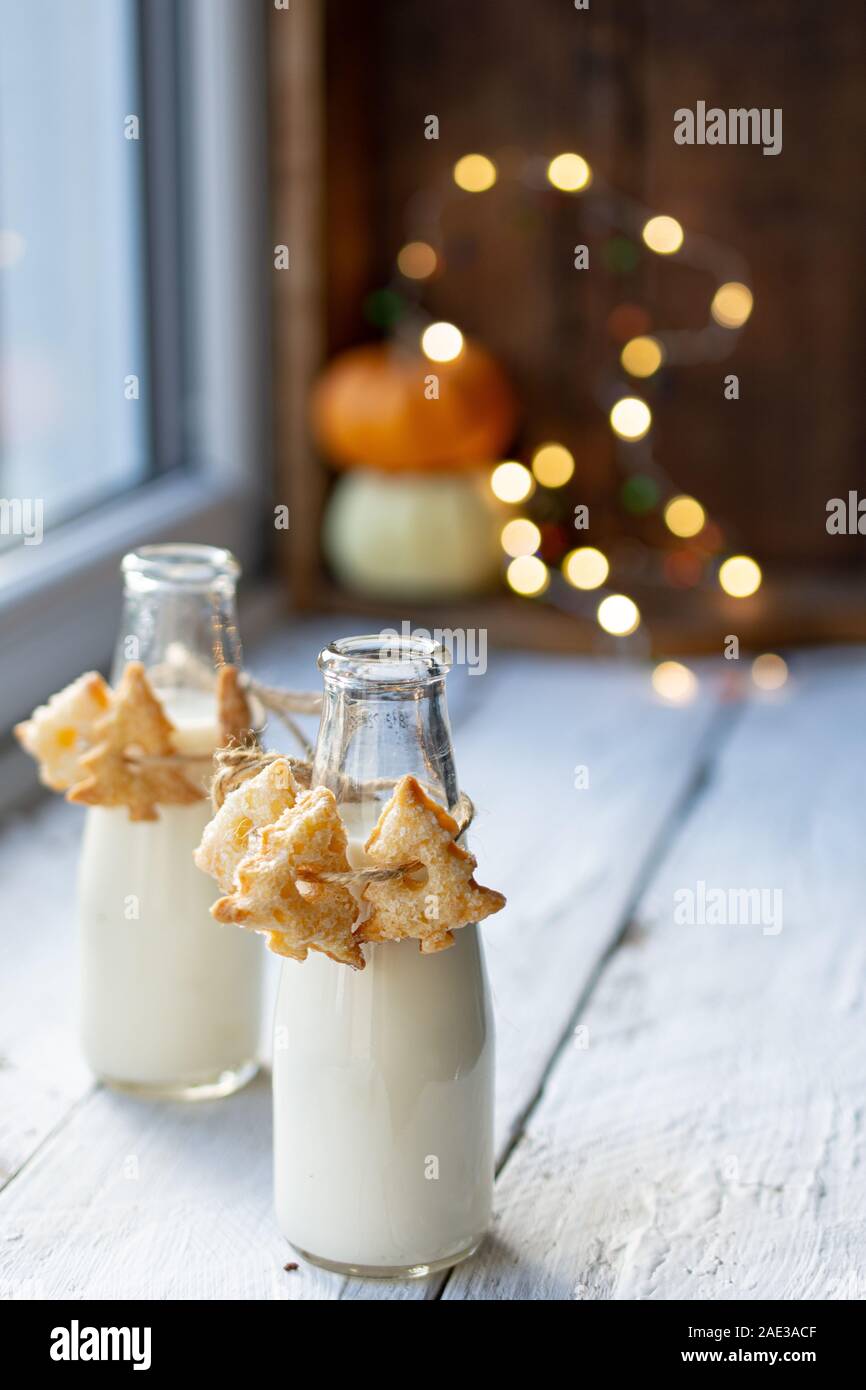 Christmas cookies hung on milk bottles.Healthy food and drink.Delicious protein Stock Photo