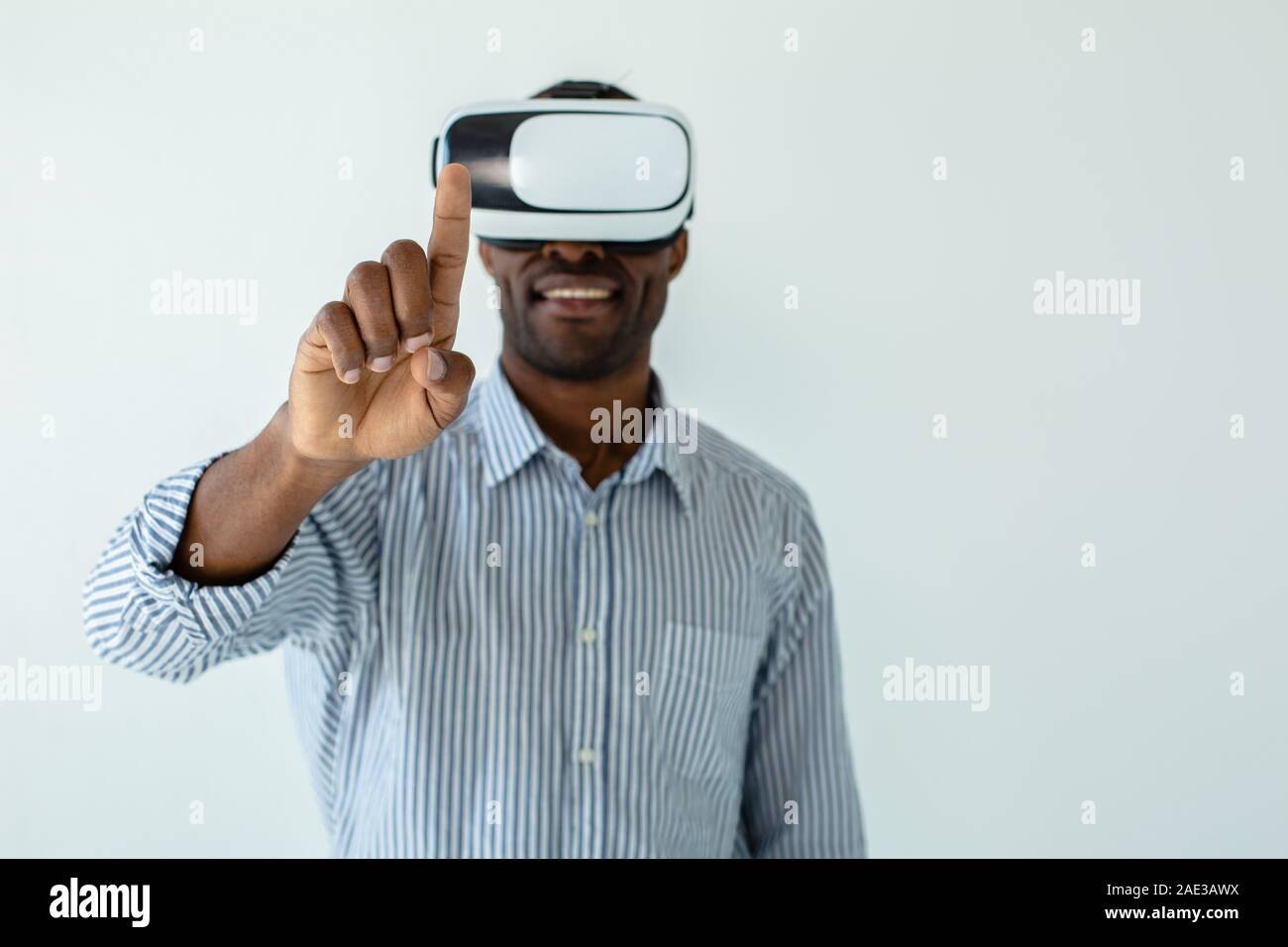 African American young man wearing vr virtual reality headset over ...