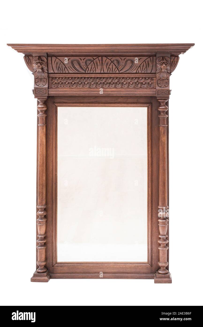 Antique mirror with carved wood frame on the white background. Stock Photo