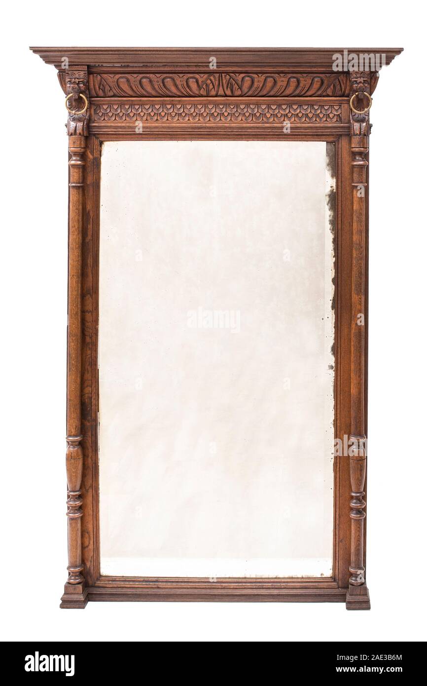 Antique mirror with carved wood frame on the white background. Stock Photo