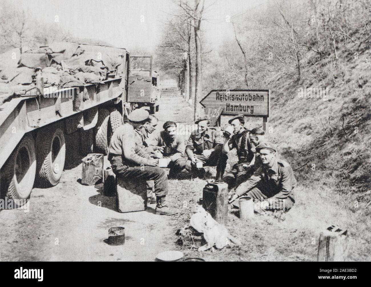 The Allied armies are marching on Hamburg. The 11th Armee transport crews during a stop on the autostrade leading to the German Grand port. Stock Photo