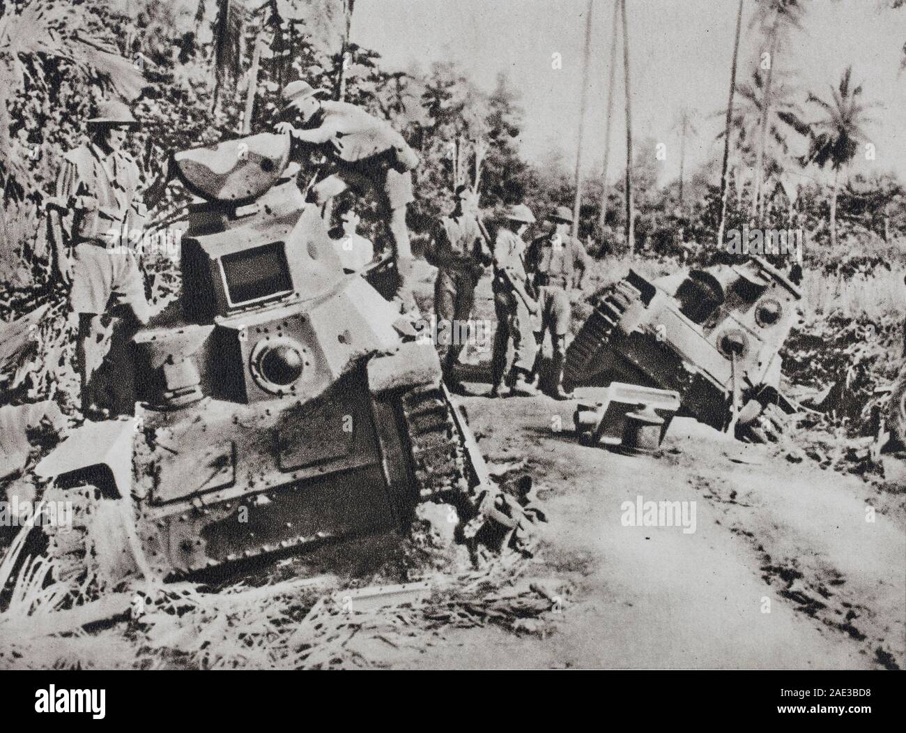 The Allies have reconquered New Guinea. The Americans and Australians inspect the Japanese tanks, which were put out of use during the fierce fighting Stock Photo