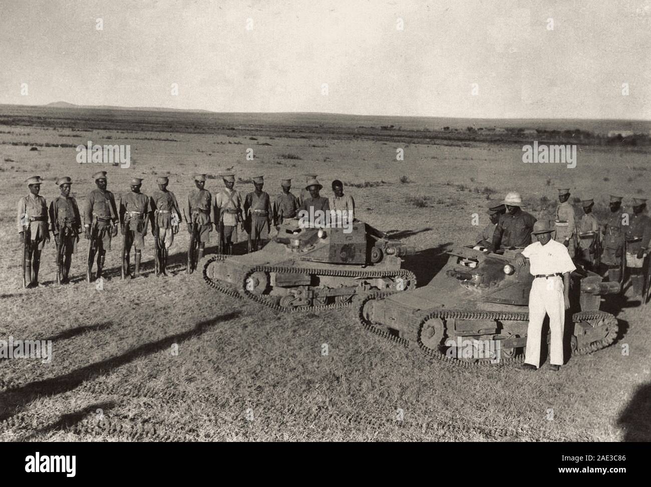 Abyssinian soldiers pose near captured Italian tanks. Stock Photo